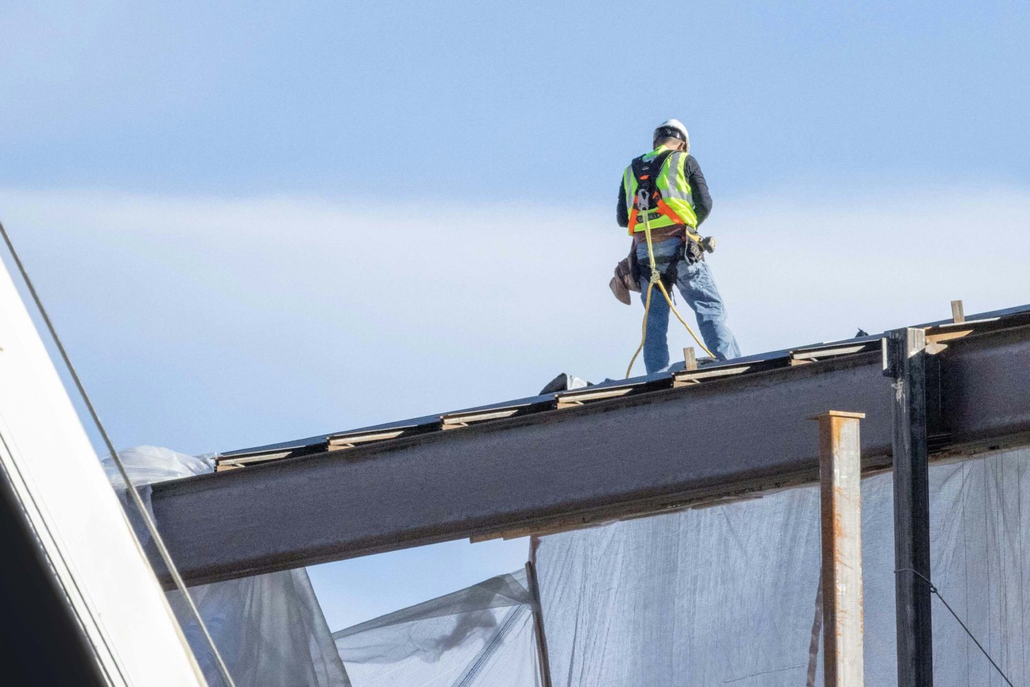 Roofer installing metal roofing